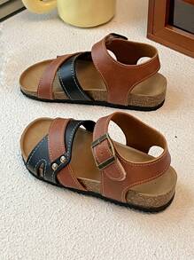 This Is A Pair Of Best-Selling Girls' Sandals. The Upper Is Made Of Brown And Black Leather. The Cross-Strap Design Adds A Sense Of Layering, And It Is Equipped With Metal Buckles To Adjust The Tightness. It Is Convenient To Put On And Take Off. The Upper Layer Of The Sole Is Made Of Cork, Which Fits The Feet Closely And Provides Comfort.