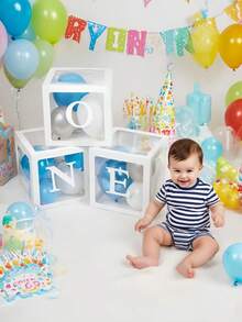 适合男孩或女孩的一周岁生日装饰套装，包含3个“ONE”字样气球、透明积木拼成的“ONE TWO THREE”字母，可用作拍照道具和蛋糕背景。不含气球。 - 白色 - 查看 2