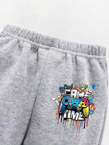 Komplet dla malucha z bluzą i spodniami z nadrukiem w kreskówkowym stylu i ciepłym okrągłym dekoltem