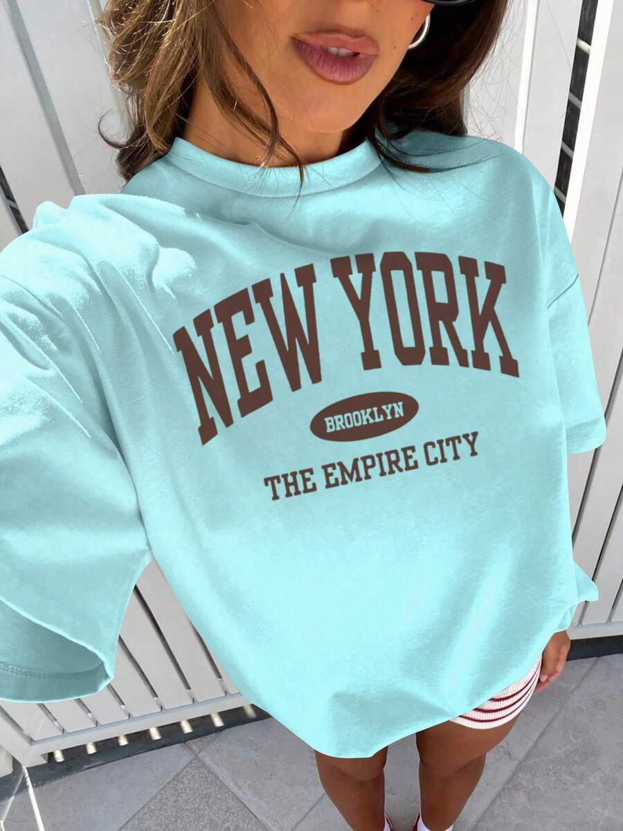 Camiseta casual suelta de verano para mujer con cuello redondo, hombros descubiertos y mangas, con estampado de letra para uso diario y versátil. Blusas gráficas para mujer en blanco, negro y rosa, para outfits de vacaciones - Azul - Ver 1