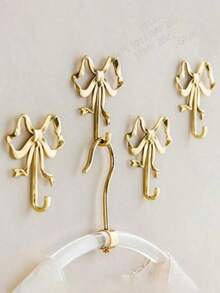 金色蝴蝶结壁钩，金色蝴蝶结衣架，黄铜蝴蝶结壁钩，门钩，毛巾钩，黄铜衣钩，适用于婚礼、浴室、客厅、厨房装饰的挂钩，黄铜金属壁挂式衣架，适用于客厅和浴室，烤漆表面，易于安装，复古丝带设计挂钩，适用于卧室和浴室，北欧复古衣钩，衣钩，卧室门廊浴室装饰，实心黄铜蝴蝶结形壁钩 - 彩色 - 查看 1