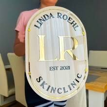 Personalisiertes beiges ovales Schild mit goldenen und schwarzen Buchstaben, goldener Umrandung, Montagematerial enthalten. Transparentes ovales Schild mit schwarzen und goldenen Buchstaben und goldener Umrandung, Montagematerial enthalten. Kundenspezifisches Acryl-Geschäftsschild für die Wand mit weißem Hintergrund, personalisiertes Geschäftsschild für das Büro