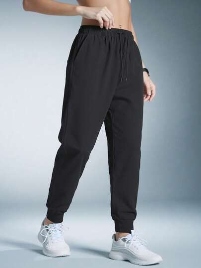 Calça casual feminina preta leve e respirável com cordão na cintura, adequada para ioga e uso diário