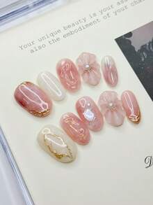 10 móng giả hình oval cỡ trung bình với tông màu hồng nude và trắng nhạt chủ đạo, cánh hoa 3D (đính ngọc trai), đường viền lá vàng, mảnh vỏ sò óng ánh tạo nên không gian lãng mạn và tinh tế, móng acrylic dán thủ công 100% có thể tái sử dụng dành cho nữ dùng hàng ngày hoặc dự tiệc. - Nhiều màu - Xem 14