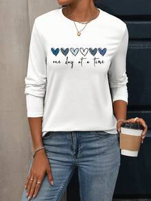 Camiseta de manga larga con cuello redondo de talla grande para mujer, camiseta estampada con patrón de corazón, camiseta estampada con el lema "Un día a la vez", adecuada para el uso diario en otoño, camiseta de otoño e invierno para mujer, camisetas gráficas para mujer