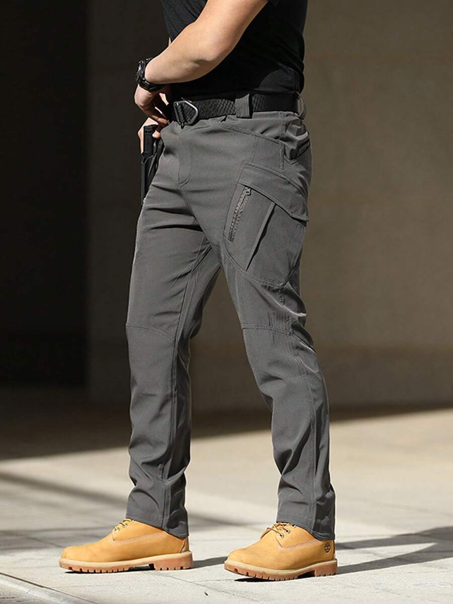 Pantalones tácticos multibolsillos para hombre están hechos de tela duradera y resistente al agua y cuentan con bolsillos laterales y cremalleras. - Gris - Ver 1