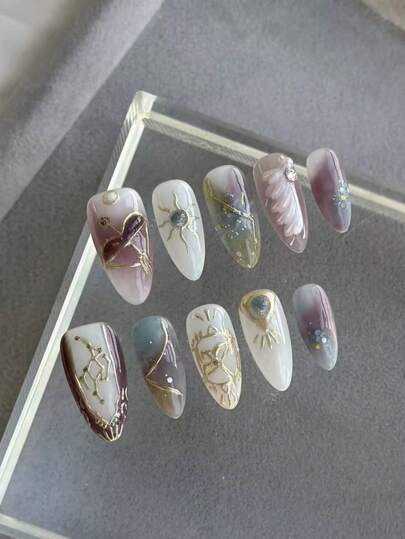 Valentine's Day Manicure, Luxurious And Elegant Western Style, Ten Medium-Length Almond-Shaped Pressed Fake Nails In Various Colors Such As Light Purple, Light Green, And White, With Rich And Mixed Shading Of Colors, Gold Powder Outlining The Shape Of Sagittarius, The Sun Goddess, Blue Sapphire, White Feathers, And Pearls As Embellishments,