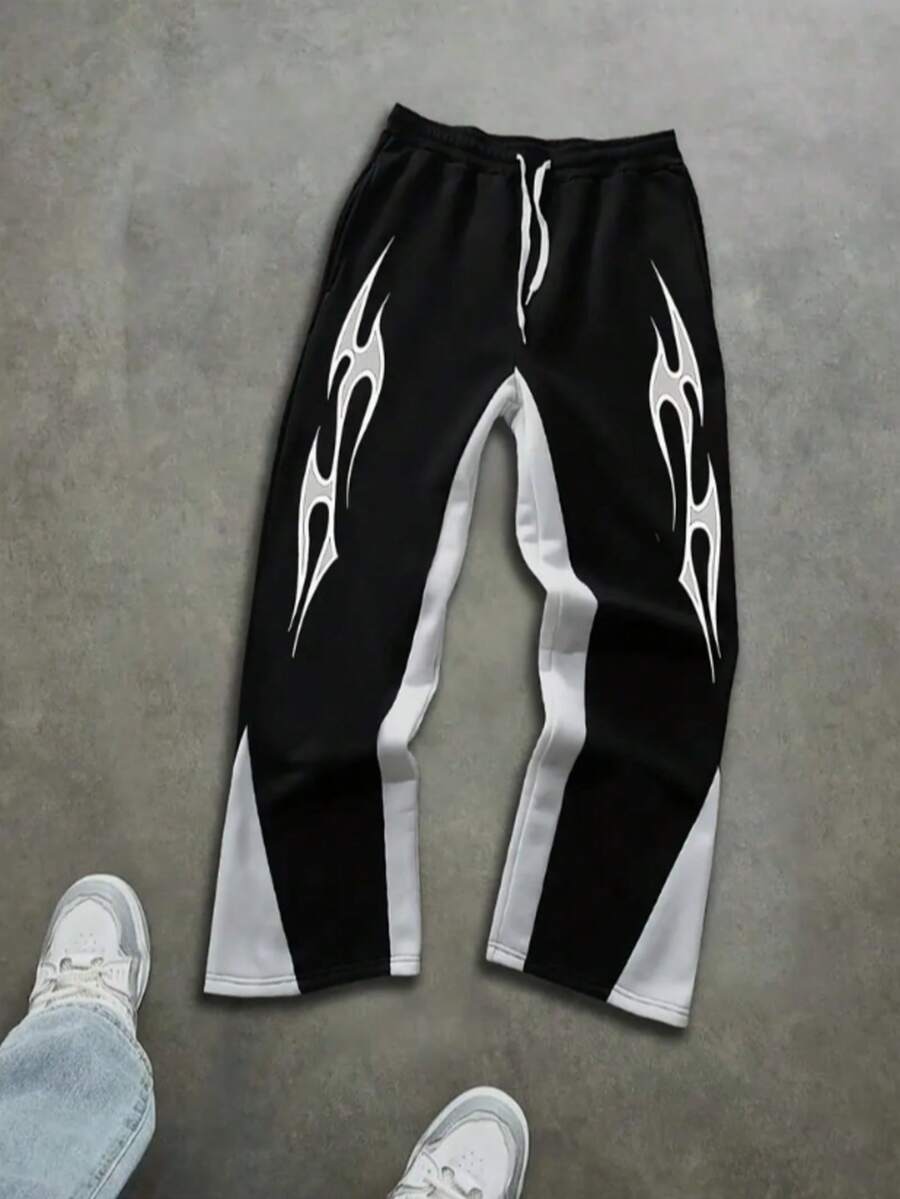Pantalones sanitarios modernos y modernos para hombre con estampado de contraste de color y patrón de llamas, pantalones para hombre con diseño de contraste de color con cordón, tela de poliéster transpirable y antitranspirante, con bolsillos y cintura elástica, estilo callejero underground, patineta, hip-hop y rap. - Negro - Ver 1