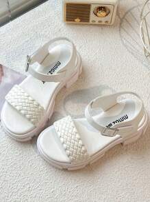 A Pair Of Children's/Girls' Sandals. The Main Body Of The Upper Is White. The Cross-Woven Straps Are In A Combination Of And Pink. There Is A Metal Buckle Strap At The Ankle.