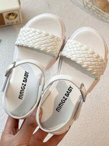A Pair Of Children's/Girls' Sandals. The Main Body Of The Upper Is White. The Cross-Woven Straps Are In A Combination Of And Pink. There Is A Metal Buckle Strap At The Ankle.