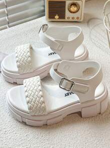 A Pair Of Children's/Girls' Sandals. The Main Body Of The Upper Is White. The Cross-Woven Straps Are In A Combination Of And Pink. There Is A Metal Buckle Strap At The Ankle.