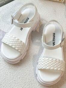 A Pair Of Children's/Girls' Sandals. The Main Body Of The Upper Is White. The Cross-Woven Straps Are In A Combination Of And Pink. There Is A Metal Buckle Strap At The Ankle.