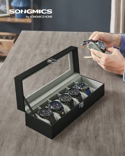 SONGMICS Caja de Relojes con 6 Compartimentos, Estuche de Relojes con Tapa de Cristal, Cojín Extraíble, Cierre Metálico, Regalo, Cuero Sintético Negro y Forro Gris Verdoso, Regalo de Navidad
