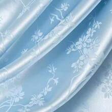 一块梅花图案的提花缎面料，质地柔软，深色提花面料，精致典雅，是DIY手工和缝纫的完美选择