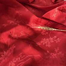 一块梅花图案的提花缎面料，质地柔软，深色提花面料，精致典雅，是DIY手工和缝纫的完美选择