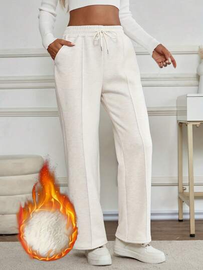 女士保暖内衬纯色休闲运动长裤，带抽绳口袋，适合秋冬季户外穿着，抓绒材质