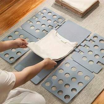 Adjustable Plastic Clothing Folding Plate - A Quick And Easy Laundry Organizer For Home Storage, Which Can Efficiently Store Clothes. A Multi-Functional Laundry Room Accessory For Home Organization. Available In Multiple Colors For Color Music Festivals, Running Of The Ox Festival, Torch Festival, Edinburgh International Festival, Halloween, Hanukfestival, Christmas, And Festival Gifts