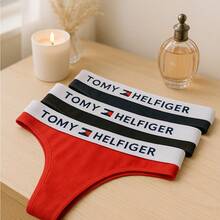 Set de 3 tangas de algodón TOMY HELFIGER para mujer, ropa interior cómoda y ligera con elástico suave en la cintura que no marca la piel, ideal para uso diario y moda íntima juvenil y casual. Diseño clásico tipo tanga con costuras delicadas y ajuste perfecto en cadera y cintura, confeccionadas en algodón transpirable que ofrece frescura durante todo el día. Colores surtidos rojo, negro y azul marino fáciles de combinar con brasieres y tops, prendas de lencería versátiles para ocasiones casuales o especiales. Tanga de mujer con estilo moderno, sexy y discreto debajo de cualquier prenda de vestir. Pack de 3 piezas de ropa interior femenina de calidad premium, pensadas para brindar comodidad, durabilidad y estilo en el día a día. - Multicolor - Ver 4