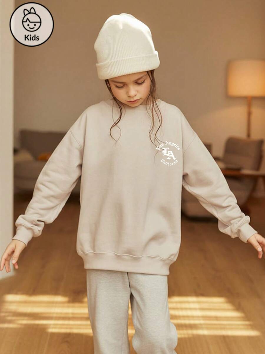 Pull ample à col rond avec imprimé lettre pour préadolescentes. Chemise de fond à manches longues pour l'automne et l'hiver. Haut abricot