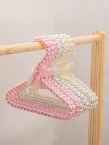 1/3/5/10件仿珍珠衣架，带蝴蝶结，仿珍珠裤夹，适合儿童使用的小型衣架和宠物衣架。这款挂衣架适合悬挂仙女风格的服装，例如连衣裙、裤子、鞋子、牛仔裤、靴子和裙子。它适合春季的极简主义风格，也可用于悬挂夏季上衣。
