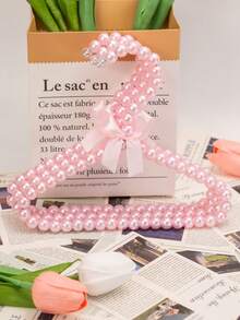 1/3/5/10件仿珍珠衣架，带蝴蝶结，仿珍珠裤夹，适合儿童使用的小型衣架和宠物衣架。这款挂衣架适合悬挂仙女风格的服装，例如连衣裙、裤子、鞋子、牛仔裤、靴子和裙子。它适合春季的极简主义风格，也可用于悬挂夏季上衣。