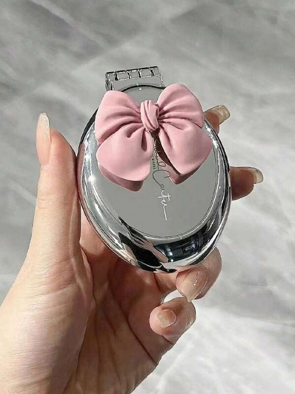 مرآة مدمجة جميلة باللونين الوردي والفضي مع فيونكة ثلاثية الأبعاد، مرآة جيب مكبرة قابلة للطي من الجانبين، تصميم معدني لامع محمول باليد مناسب للحقيبة والمكياج والتجميل أثناء السفر، هدية جمالية للنساء والفتيات