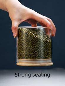 高硼硅玻璃密封储物罐，适用于存放谷物、麦片、干果、柑橘皮和茶叶。直筒圆柱形设计，配竹制盖子，简约透明，是家居收纳的理想之选。
