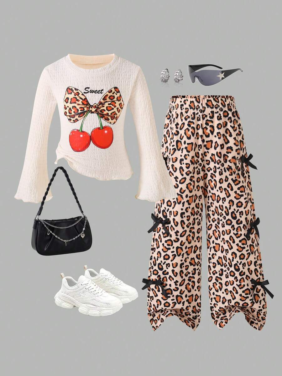 Bộ đồ họa tiết da báo dễ thương và vui tươi dành cho bé gái, gồm áo in họa tiết đáng yêu có tay áo bo nơ, kết hợp với quần họa tiết da báo thời trang, hoàn hảo cho việc chơi hàng ngày hoặc đi chơi cuối tuần, phù hợp cho mùa xuân, thu và đông - trắng - Xem 1