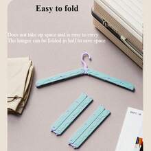 这款可折叠旅行无痕衣架内置多功能夹子，采用防滑承重设计，并配有圆润的肩部护垫，可保护精致衣物。它是一款节省空间的便携式衣橱配件，专为商务旅行、酒店、家庭、户外探险、宿舍和学生设计。超轻便，折叠和展开都非常方便，能够保持衣物洁净如新，是旅行的理想之选。红色款。