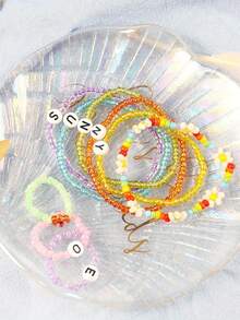 Zestaw 24 kolorowych szklanych koralików nasiennych – 2 mm (11520 szt.), 3 mm (5760 szt.), 4 mm (1920 szt.) – wielokolorowy asortyment do tworzenia biżuterii, rękodzieła, scrapbookingu, bransoletek i akcesoriów rękodzielniczych - Krem - Zobacz 7