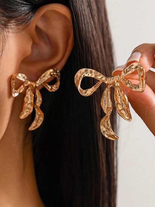 1 par de aretes simétricos de moda con diseño geométrico de moño