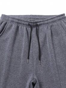 男士保暖运动裤，带口袋和抽绳，撞色皮革贴片，腰部可调节，裤脚收口，穿着舒适。 - 深灰色 - 查看 3