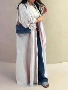 Chiếc áo choàng nữ cổ điển thanh lịch với dây rút ở cổ tay này toát lên vẻ quý phái và duyên dáng, phù hợp cho mọi mùa và nhiều sự kiện văn hóa khác nhau. - Màu Xám nhạt - Xem 1