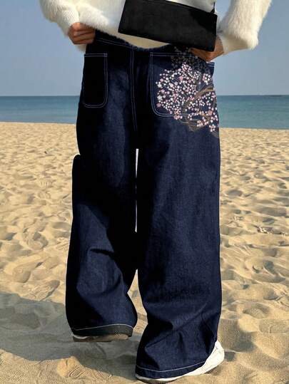 Trendiga vintagejeans med broderad körsbärsblomma och vida ben och lös passform