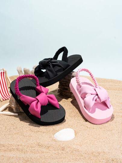 Chanclas para bebé con correa elástica, fácil de poner y quitar, tela de unicolor con diseño de lazo, adecuadas para uso diario de niños, suaves y gruesas, cómodas y antideslizantes para interiores/exteriores