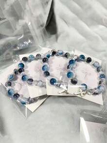 1pc Cool Blue Cross Bracelet. Transparent Blue Crystals Are Strung Together To Form The Chain, Adorned With A Silver Cross Pendant, Exuding A Cool And Crisp Vibe. The Blue Hue Resembles The Deep, Luminous Depths Of The Ocean, While The Cross Features Clean, Sharp Lines. The Silver Chain Is Delicate And Hugs The Wrist Comfortably. Under The Play Of Light And Shadow, The Crystals Refract Delicate Blue Hues, And The Silver Accents Shimmer With A Matte, Cool White Glow. Whether Worn Alone Or Layered With Other Pieces, It Evokes A Sense Of Detachment And Minimalist Elegance, Perfectly Complementing Minimalist Outfits And A , Tranquil Aesthetic.Perfect Gift For Birthdays, Holiday Gifts, And Parties. Suitable For Daily Wear And Holiday Celebrations, Suitable For All Seasons, And Is An Ideal Choice For Holiday Accessories. - Blue - 查看 2