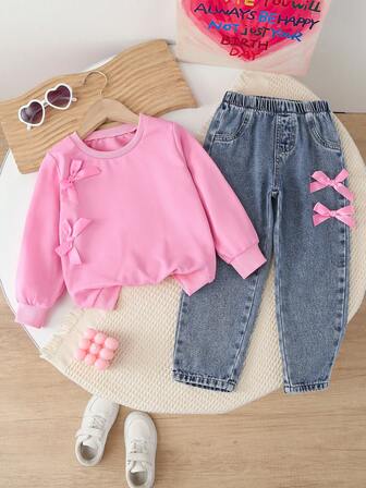 Set de 2 piezas con top rosa con lazo y pantalones vaqueros casuales con lazo y copos de nieve, nuevo estilo para otoño/invierno para niña
