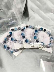 1pc Cool Blue Cross Bracelet. Transparent Blue Crystals Are Strung Together To Form The Chain, Adorned With A Silver Cross Pendant, Exuding A Cool And Crisp Vibe. The Blue Hue Resembles The Deep, Luminous Depths Of The Ocean, While The Cross Features Clean, Sharp Lines. The Silver Chain Is Delicate And Hugs The Wrist Comfortably. Under The Play Of Light And Shadow, The Crystals Refract Delicate Blue Hues, And The Silver Accents Shimmer With A Matte, Cool White Glow. Whether Worn Alone Or Layered With Other Pieces, It Evokes A Sense Of Detachment And Minimalist Elegance, Perfectly Complementing Minimalist Outfits And A , Tranquil Aesthetic.Perfect Gift For Birthdays, Holiday Gifts, And Parties. Suitable For Daily Wear And Holiday Celebrations, Suitable For All Seasons, And Is An Ideal Choice For Holiday Accessories. - Blue - 查看 2