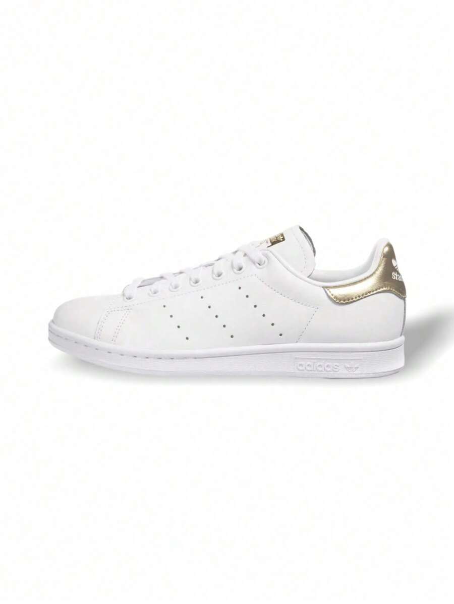 Stan Smith 女款运动鞋，皮革鞋面，金属后跟提环，OrthoLite® 鞋垫，标志性鞋舌标签 EE8836 - 白色/金色金屬色 - 查看 1