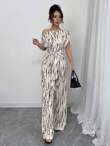 Mono de estilo bohemio para mujer con pantalones anchos con estampado integral, escote asimétrico y cintura con lazo, adecuado para diversas ocasiones como citas, trabajo, vacaciones y vida diaria.