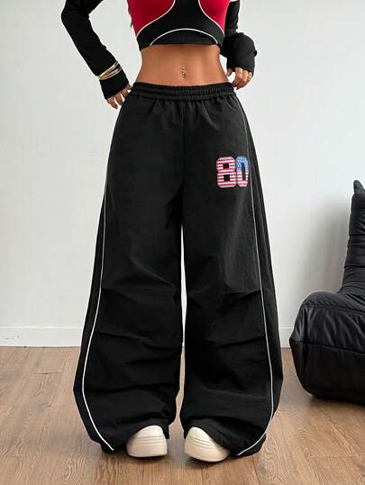 Pantalon ample à jambes larges avec poche en tissu tressé de couleur contrastée, garniture contrastée et bande réfléchissante, style universitaire, automne/hiver
