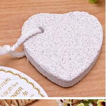 Frotar los pies con piedras flotantes para eliminar los callos, moler los pies con piedras en forma de corazón