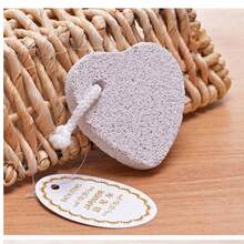 Frotar los pies con piedras flotantes para eliminar los callos, moler los pies con piedras en forma de corazón