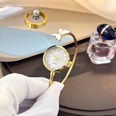 1 pezzo Orologio da polso in rame delicato da donna, cassa rotonda in lega con strass a forma di farfalla, quadrante in vetro sfaccettato, orologio al quarzo elegante e minimalista, best seller in Medio Oriente