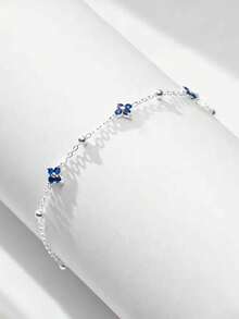 Tobillera de plata de ley 925 con trébol de cuatro hojas azul para mujer, con un diseño clásico adecuado para usar en vacaciones en la playa.