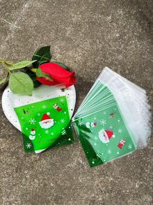 100 pièces Sacs d'emballage cadeaux verts OPP auto-scellants de 10 x 13 cm, avec motifs imprimés de Père Noël mignon et flocons de neige. Convient pour les faveurs et décorations de fête de Noël.