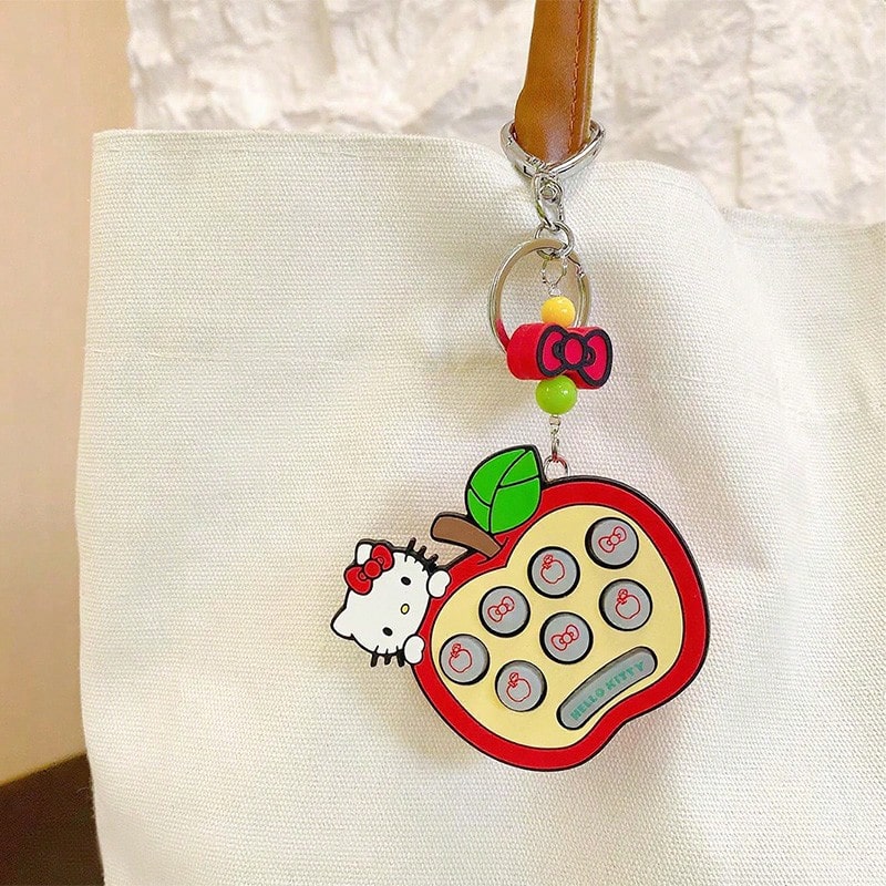Sanrio Arcade Keychain - Apple Hello Kitty Edition. Officially Licensed Retro Accessory Blending Street Culture With Kawaii Charm.