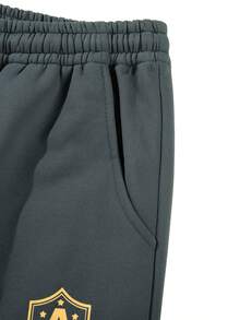 Men's Sportswear Set, Featuring A Long-Sleeved Full-Zip Sport Jacket With Embroidered Lettering And Coordinating Drawstring Athletic Pants, Designed For Both Outdoor Pursuits And Athletic Endeavors.