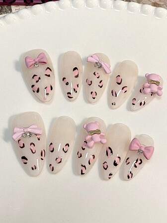 10 Pieces Acrylic Press On Nails, Almonds Fake Nails, Nail Supplies,The Transparent Base Color Is Paired With Pink And Black Leopard Print, Along With Pink Bows And Bear Decorations, Making It Extremely Cute,Suitable For Ladies To Use In Weddings, Parties, Holidays, Gift Nail Tools.