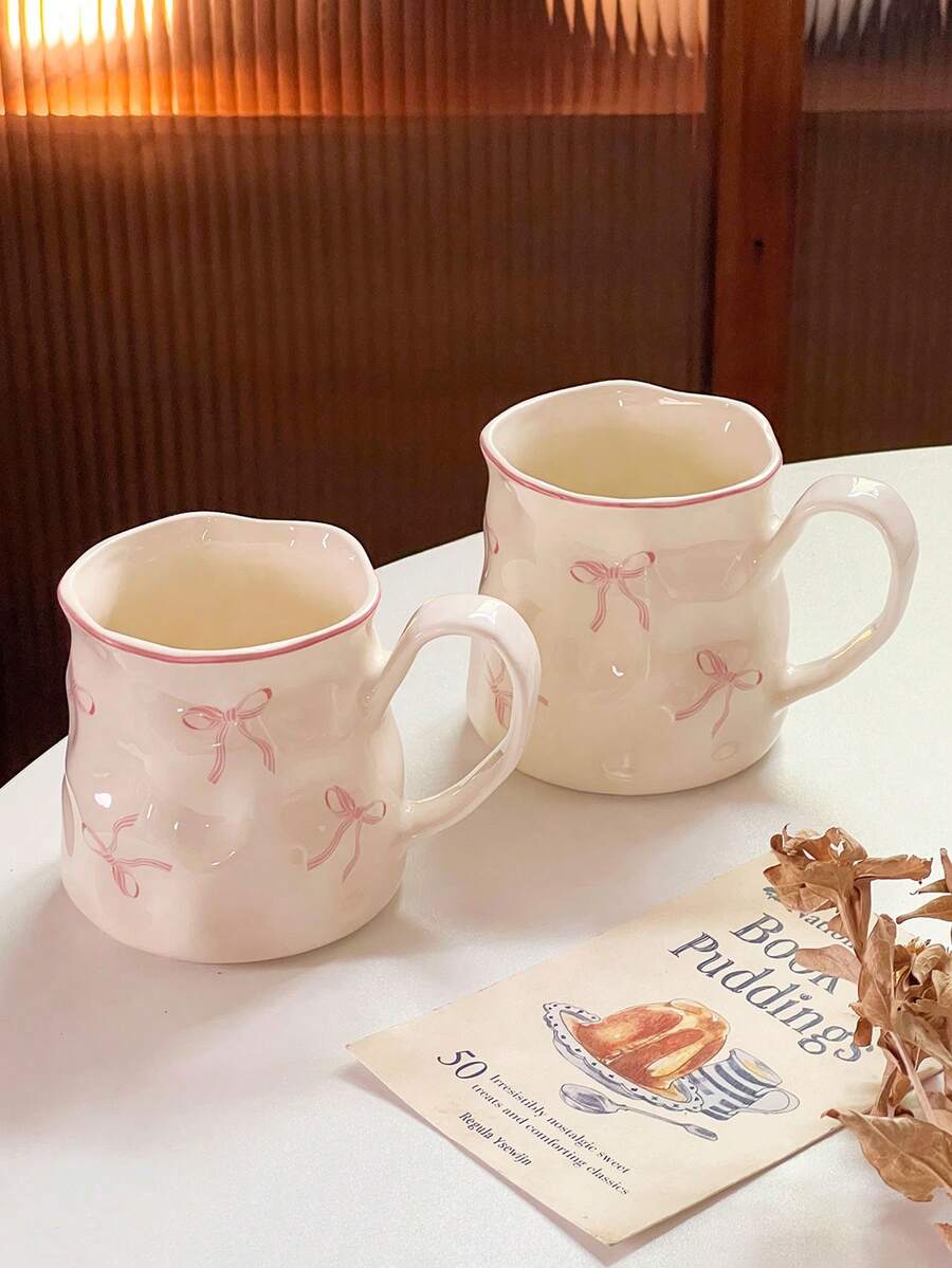 1/2件创意可爱陶瓷杯，手绘蝴蝶结图案，不对称杯身，办公休闲瓷茶杯，家用早餐杯，下午茶饮具，实用陶瓷器皿 - 彩色 - 查看 1
